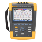 A yellow and gray Fluke 435 Series II power quality and energy analyzer displays multiple colored waveforms on its screen, with various control buttons and a navigation pad below the display.